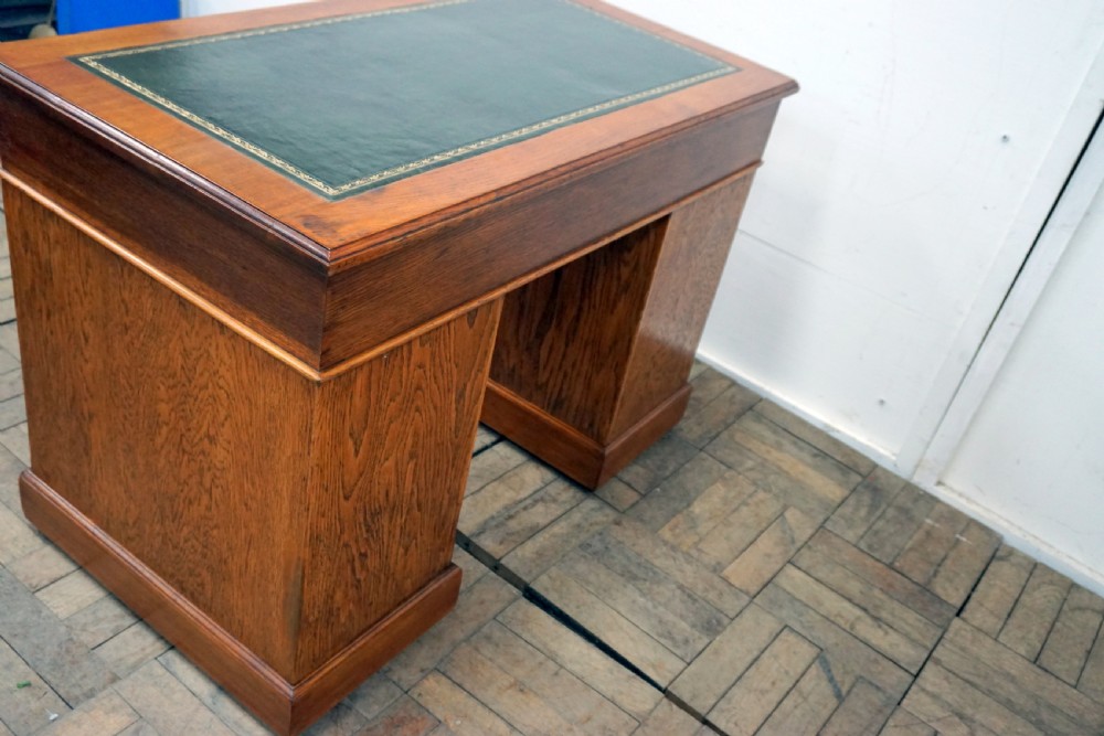 A small clean oak pedastal desk with 9 drawers View VII