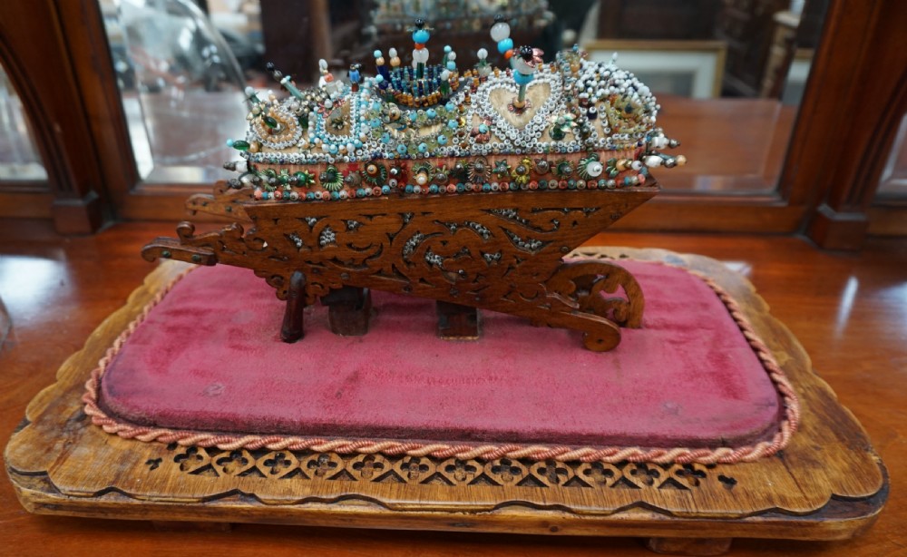 A rare and unusual beedwork wheelbarrow under dome  View II