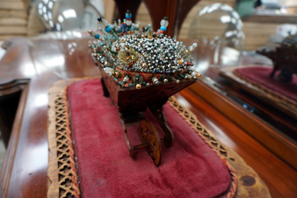 A rare and unusual beedwork wheelbarrow under dome  View III