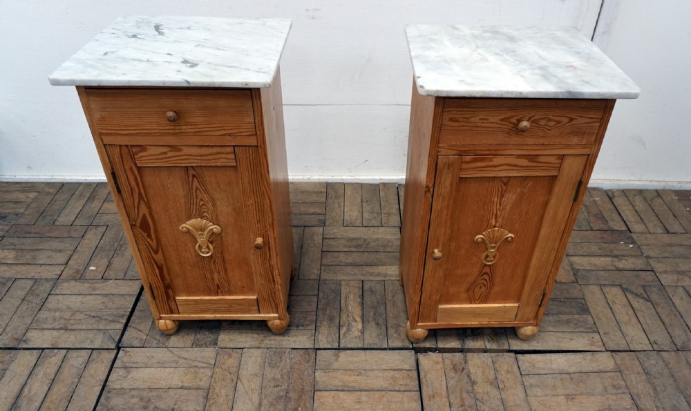 A pair of continental marble top pine bedside cabinets