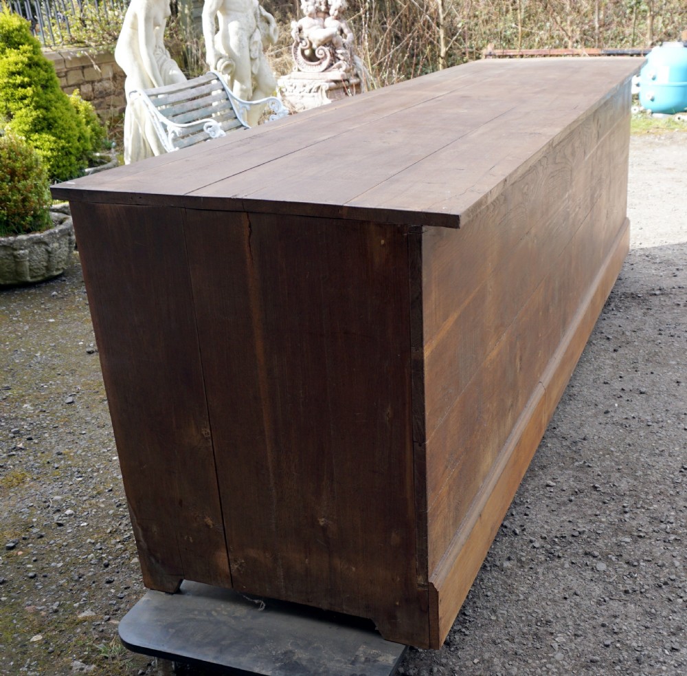 A solid oak French shop counter of impressive proportions