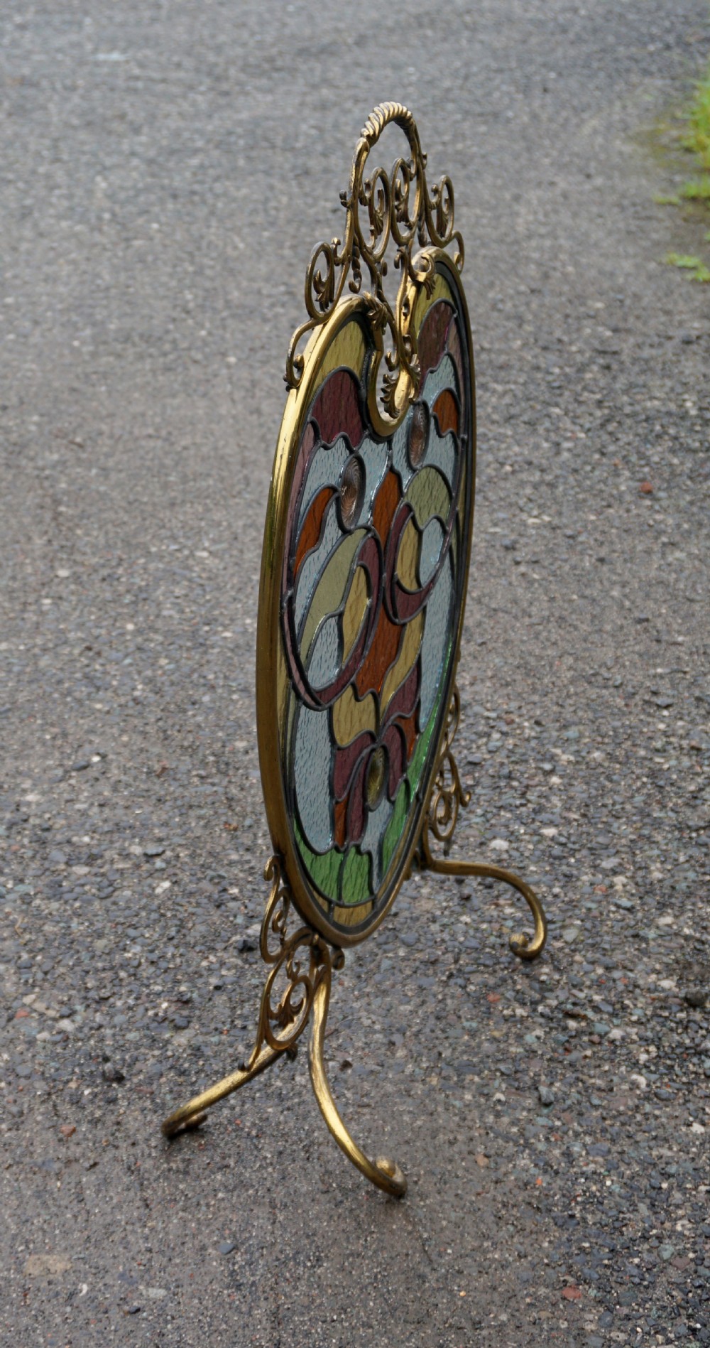 A stunning art nouveau brass and leaded glass fire screen View V