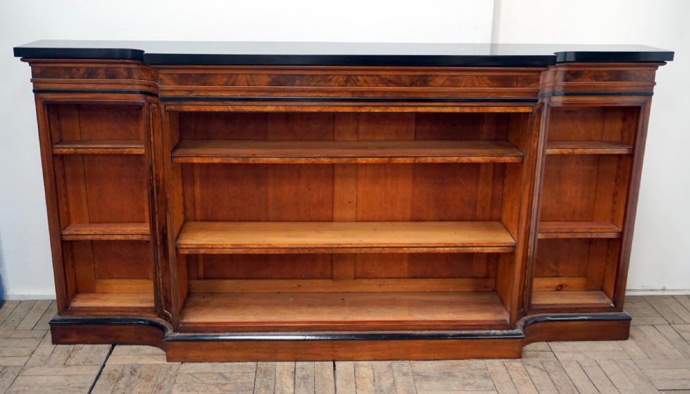 A magnificent narrow Victorian walnut and ebonised open shelf bookcase
