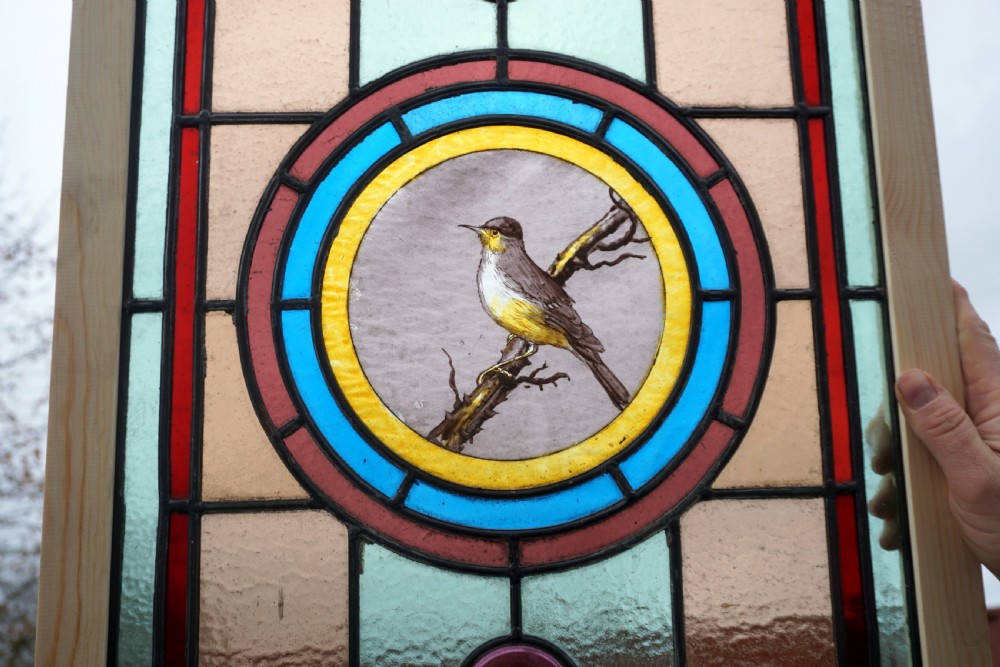 A good stained glass window with painted bird to the centre View II