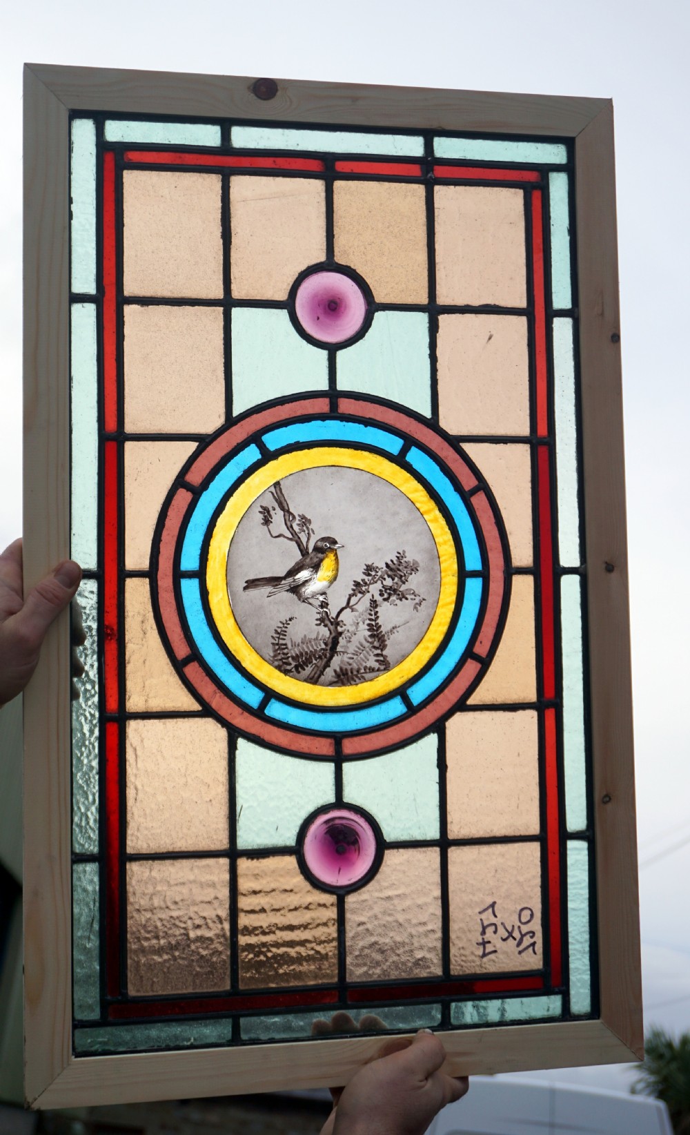 A beautiful stained glass painted bird window