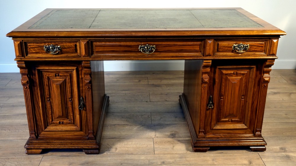 An outstanding walnut English Victorian pedastal desk by Howard and Son