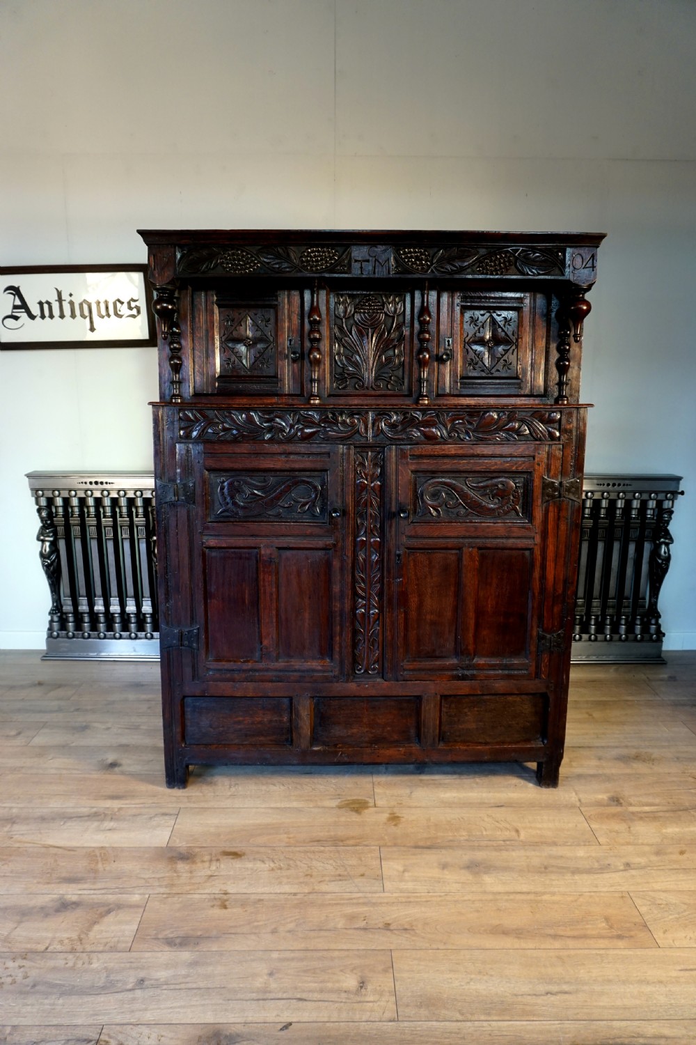 A charming original narrow oak carved court cupboard  View II