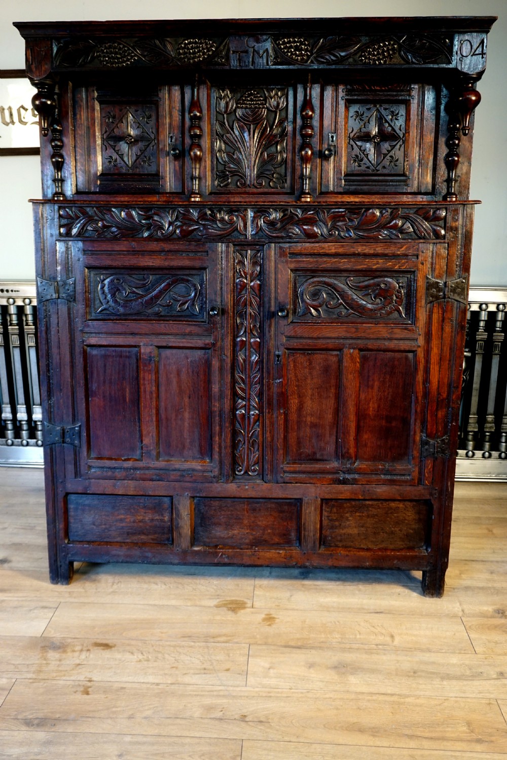 A charming original narrow oak carved court cupboard  View III