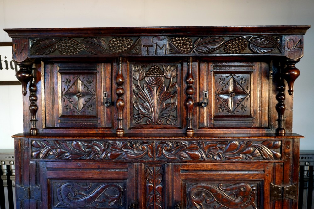 A charming original narrow oak carved court cupboard  View V