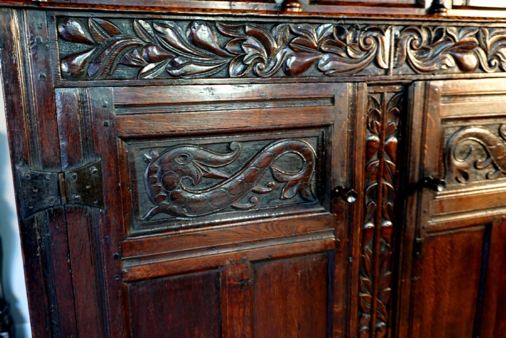 A charming original narrow oak carved court cupboard  View VI
