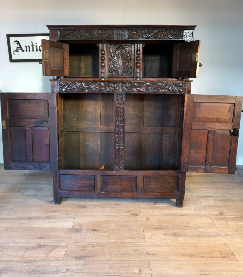 A charming original narrow oak carved court cupboard  View IX