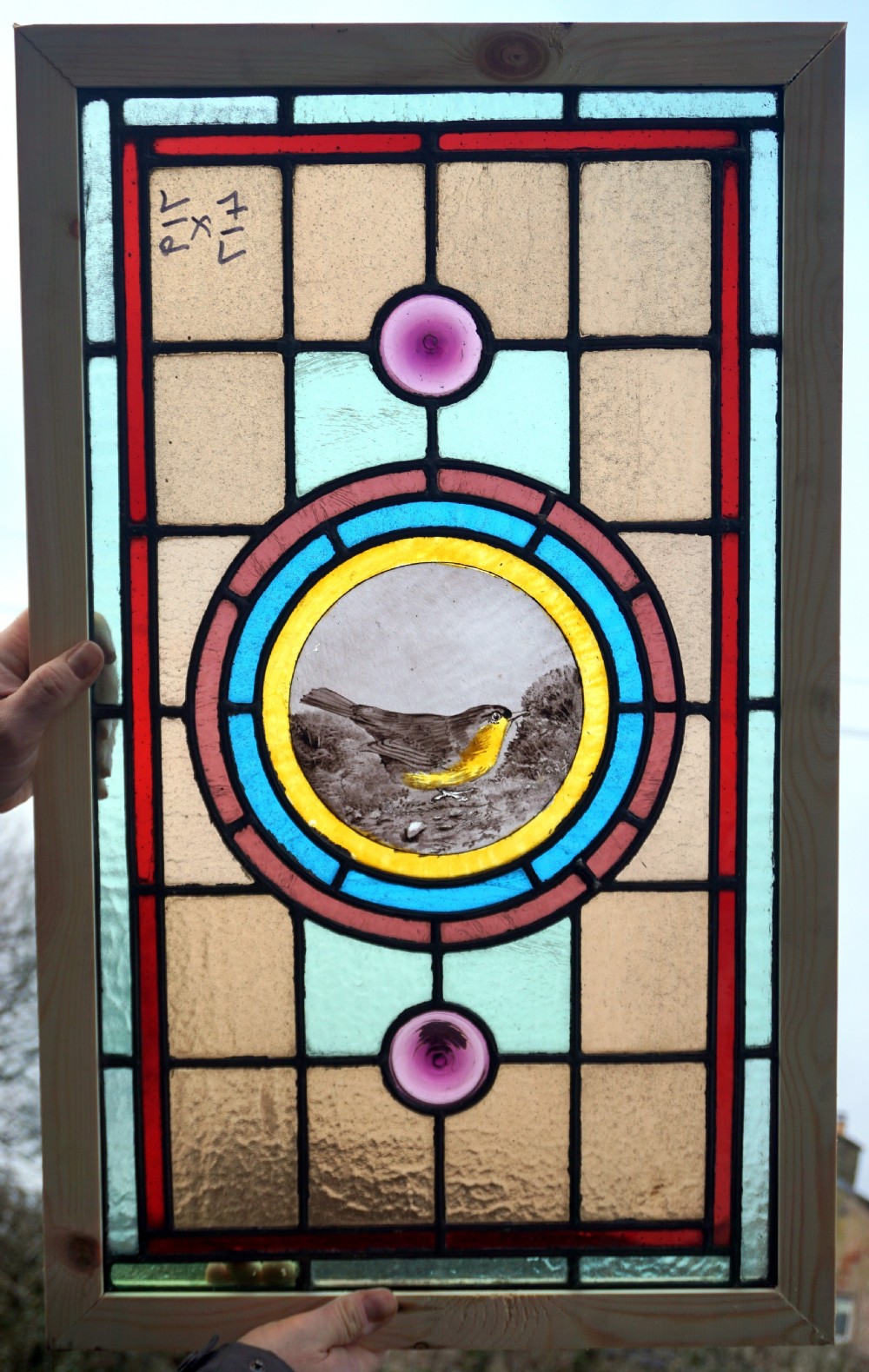 A beautiful stained glass painted bird window