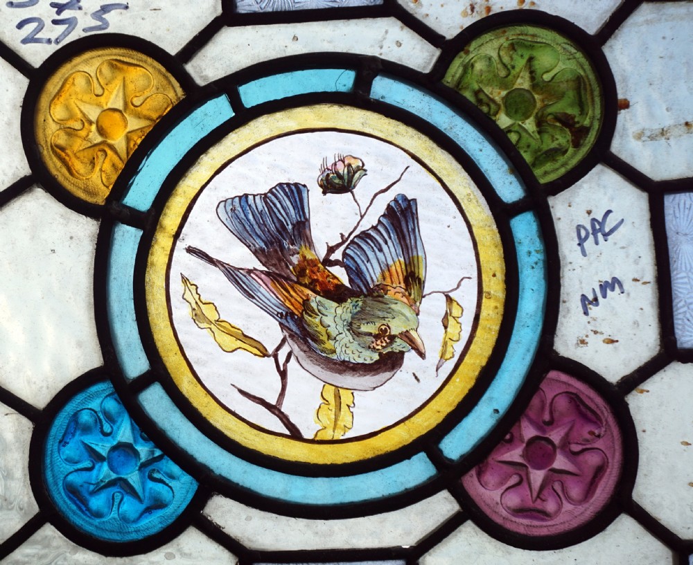 A great stained glass painted window with painted bird centre View II