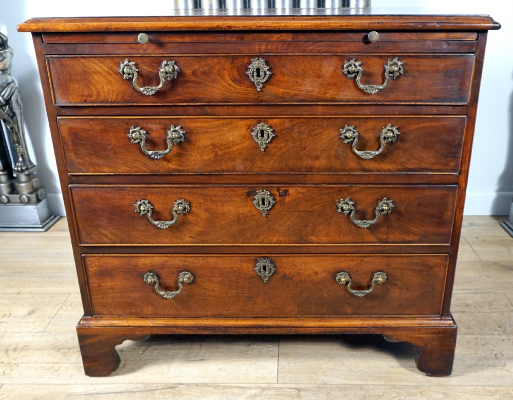 A superb example of a small Georgian chest with brushing slide 