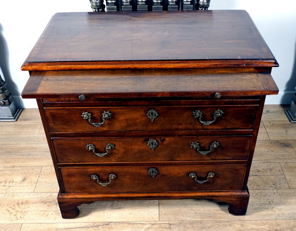 A superb example of a small Georgian chest with brushing slide  View II