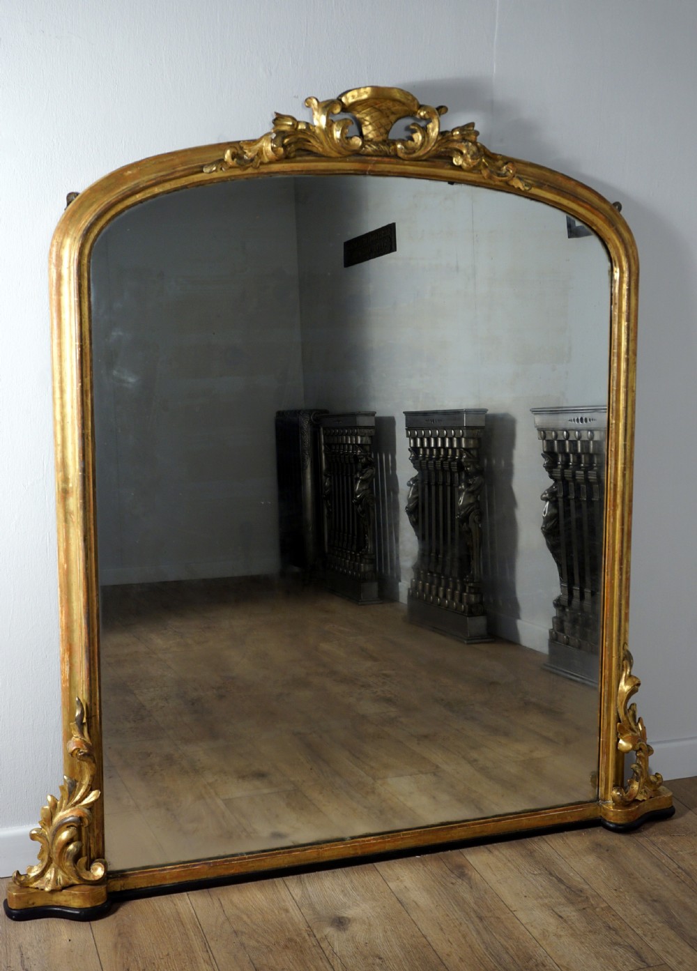 A good carved and gilded regency English overmantle mirror