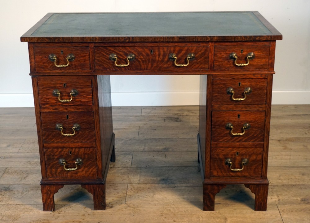A good original solid oak small size pedastal writing desk