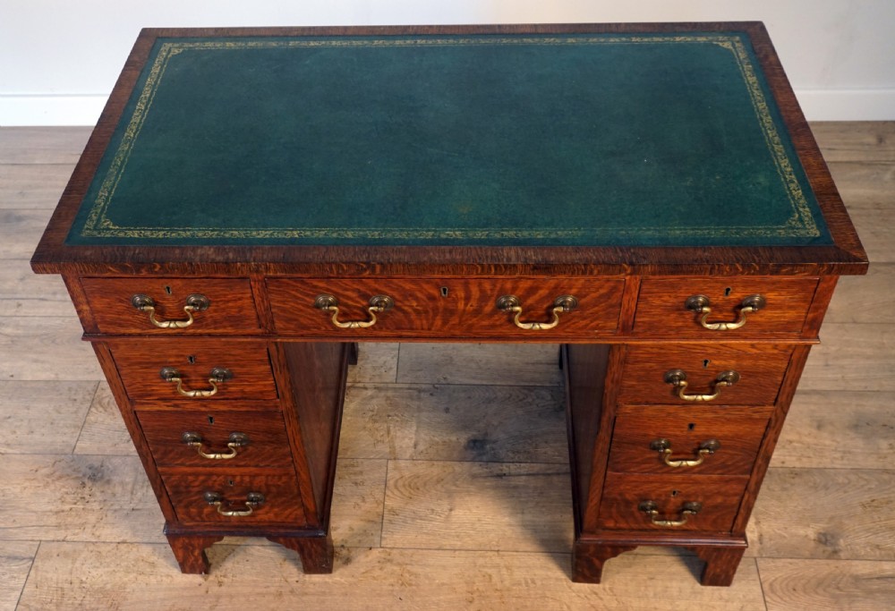 A good original solid oak small size pedastal writing desk View II