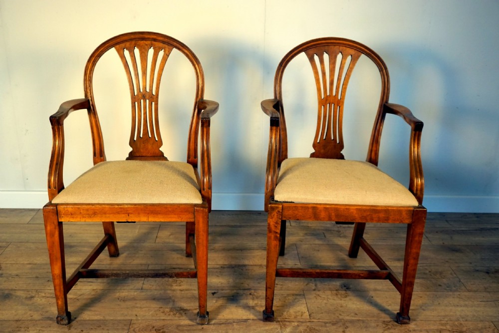A pair of wooden armchairs crafted from birch and elm with slotted back splats and light beige upholstered seats. View II