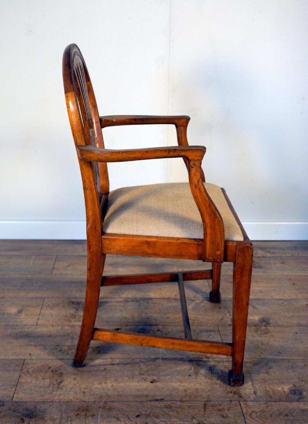 A pair of wooden armchairs crafted from birch and elm with slotted back splats and light beige upholstered seats. View III