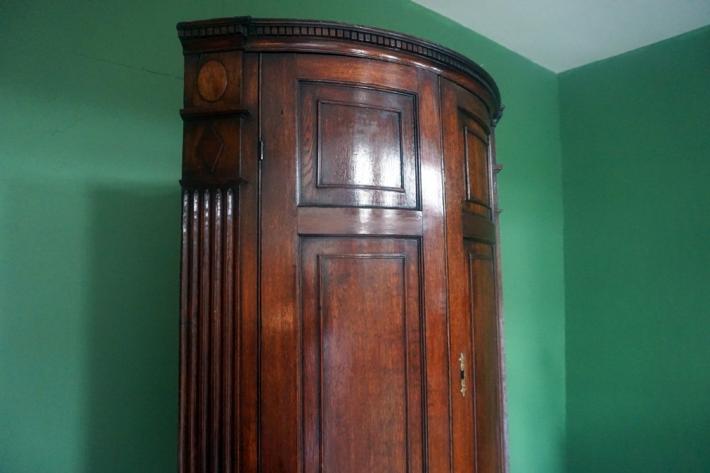 A great original example of a bow fronted Oak Georgina floor standing corner cupboard View II