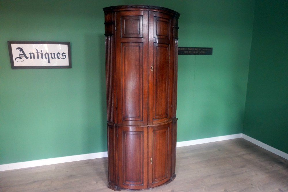 A great original example of a bow fronted Oak Georgina floor standing corner cupboard View V