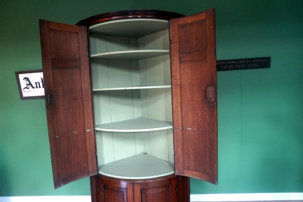 A great original example of a bow fronted Oak Georgina floor standing corner cupboard View VI