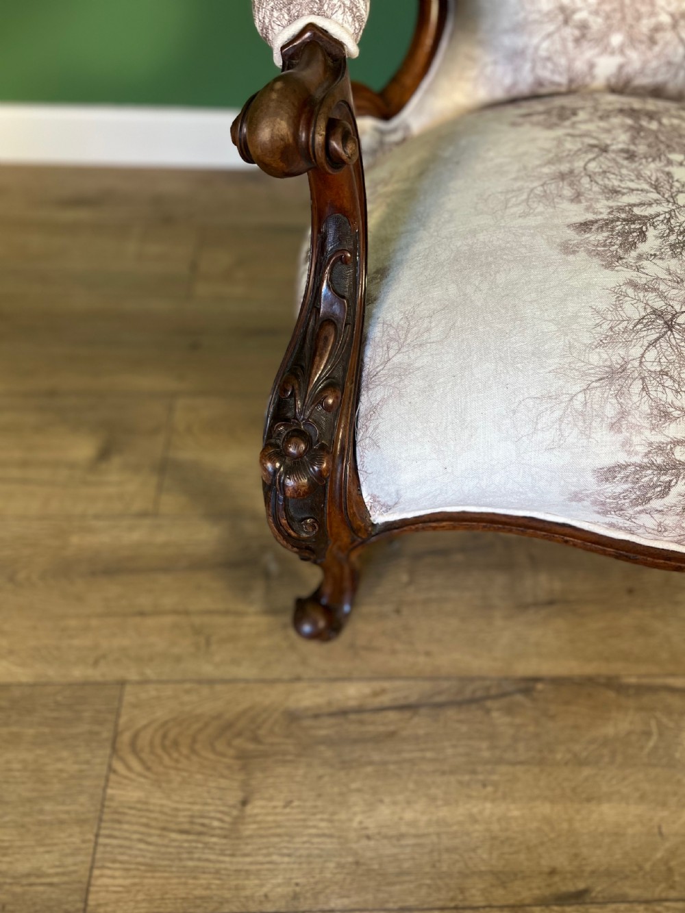 A Victorian mahogany open armchair featuring carved cabriole legs, padded armrests, and patterned fabric upholstery. View VIII