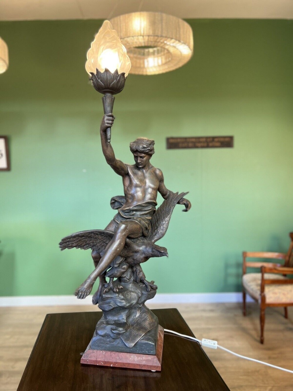 An exceptional large figure of a man on eagle lamp