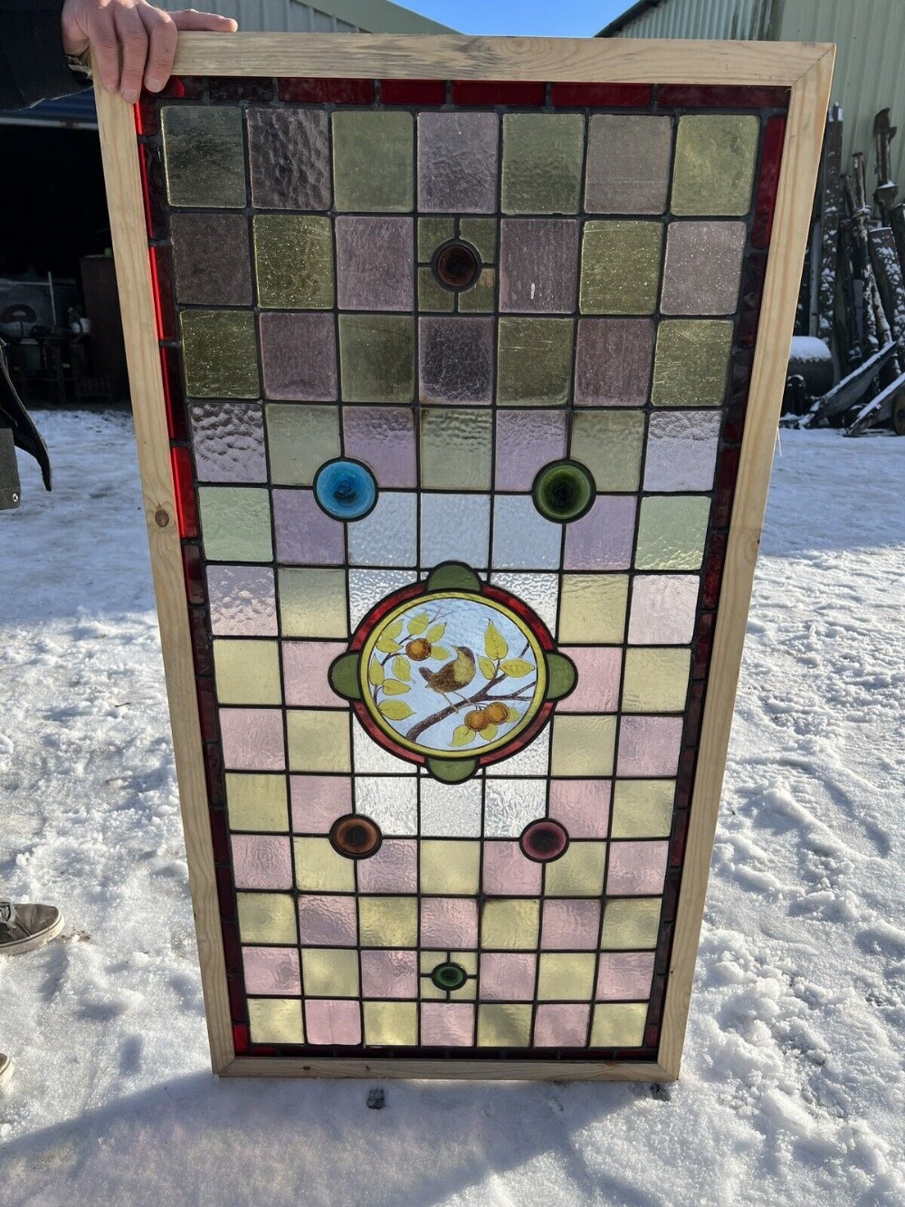 Antique leaded and painted glass window bird on a branch
