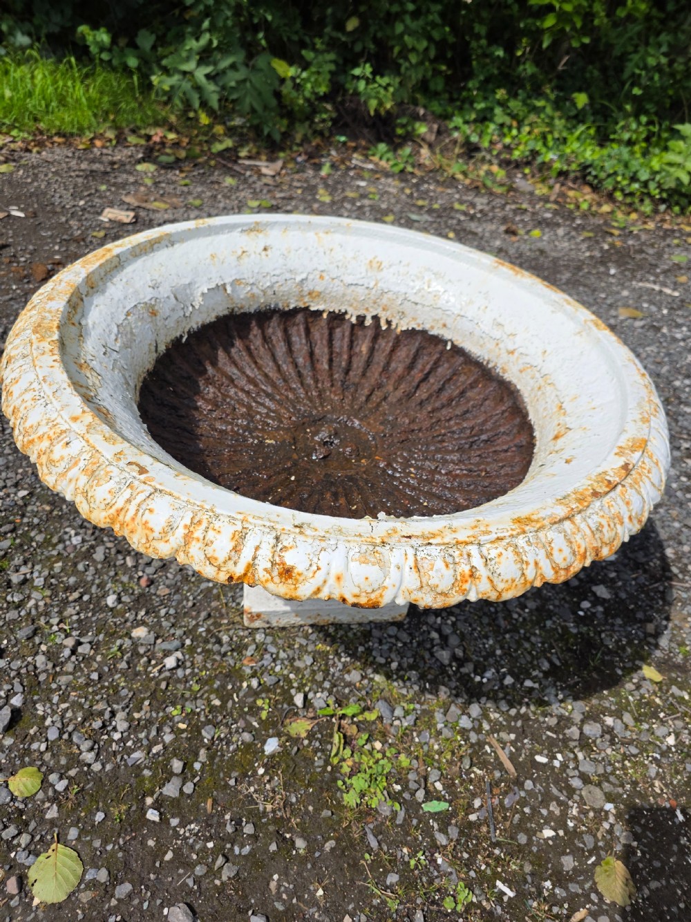 A pair of Victorian cast iron tazza garden urns with fluted basins and weathered white paint. View VIII