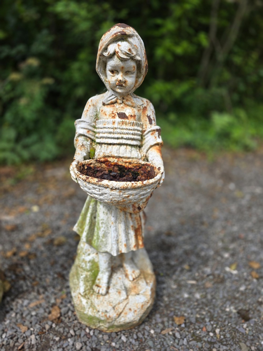 A pair of early 20th-century cast iron garden statues depicting a boy and girl in traditional attire holding small shallow basins. View III