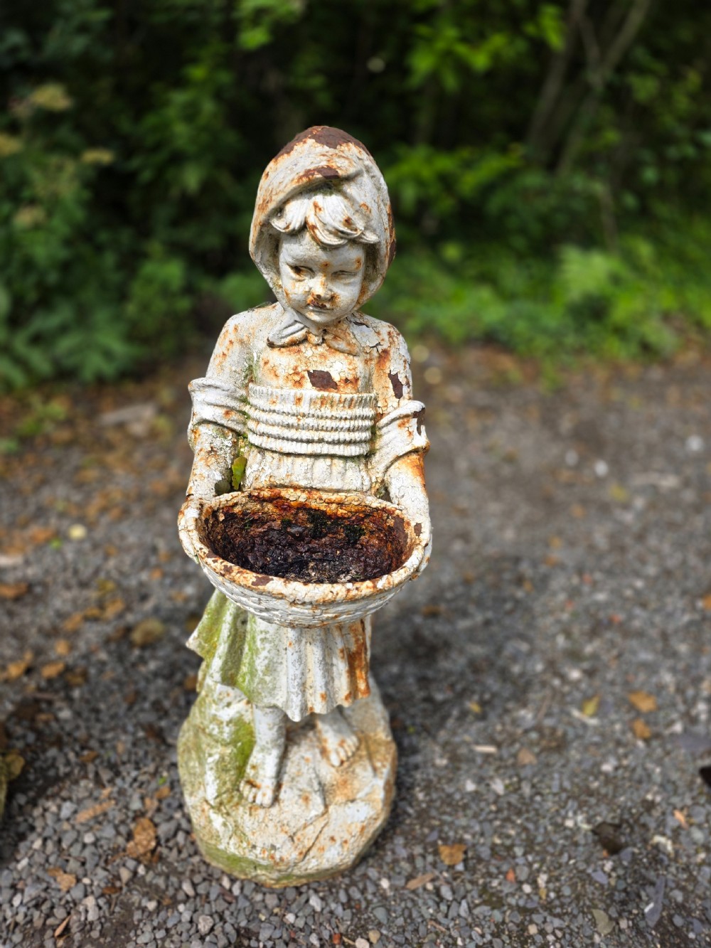 A pair of early 20th-century cast iron garden statues depicting a boy and girl in traditional attire holding small shallow basins. View IV