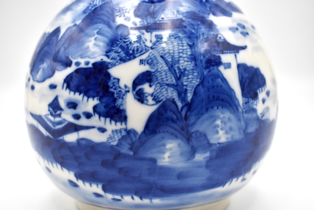 A 19th-century Chinese porcelain bottle vase with a matching lid, featuring hand-painted cobalt blue mountain landscape scenes on a white glazed body. View III