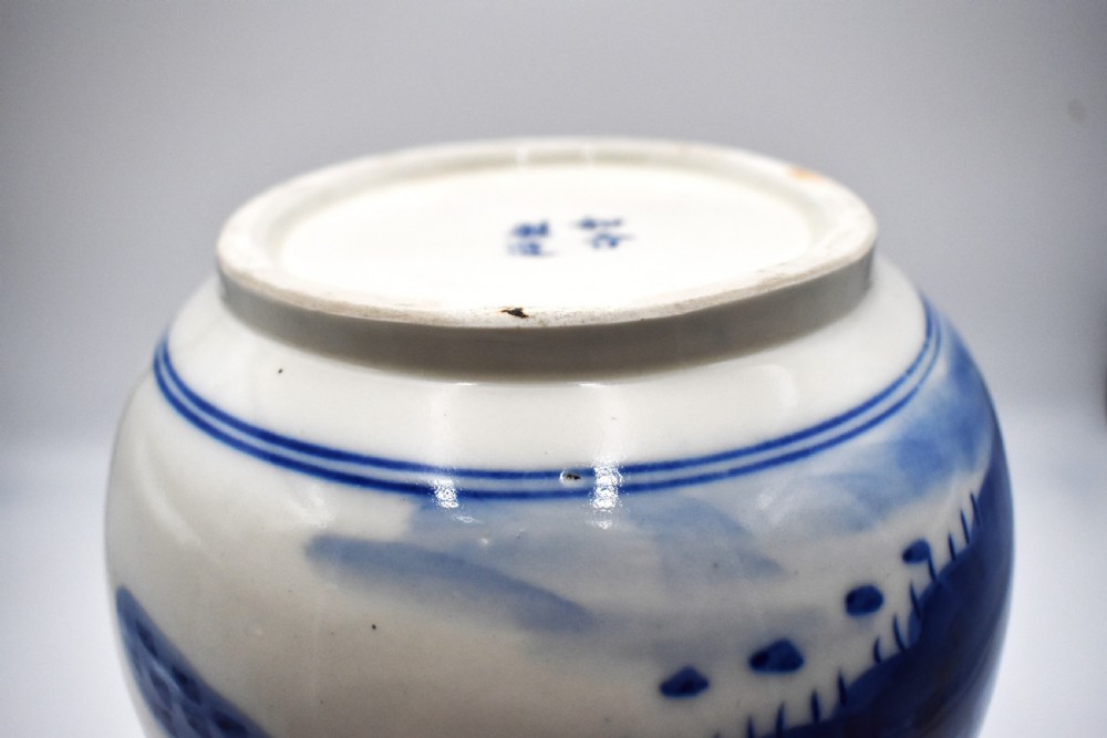A 19th-century Chinese porcelain bottle vase with a matching lid, featuring hand-painted cobalt blue mountain landscape scenes on a white glazed body. View VII