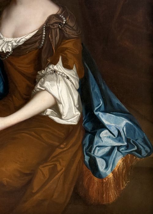 fig 5. A seventeenth-century Baroque oil portrait of a lady in a brown dress and blue drapery, set within a carved giltwood frame.