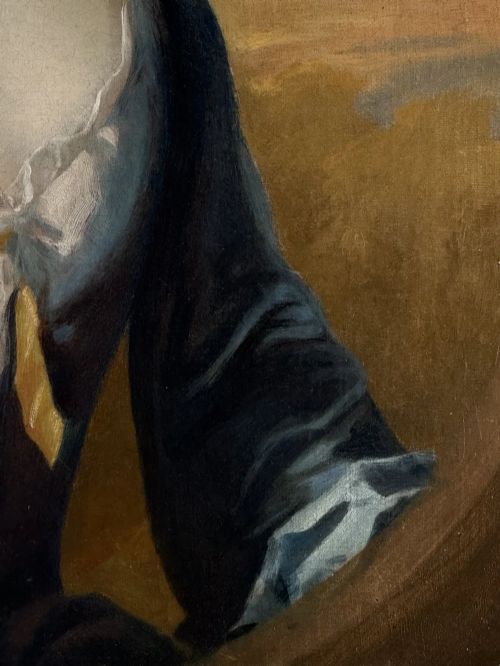 fig 3. An early eighteenth-century oil portrait painting depicting a woman in a blue dress set within an oval feigned surround and a carved giltwood frame.