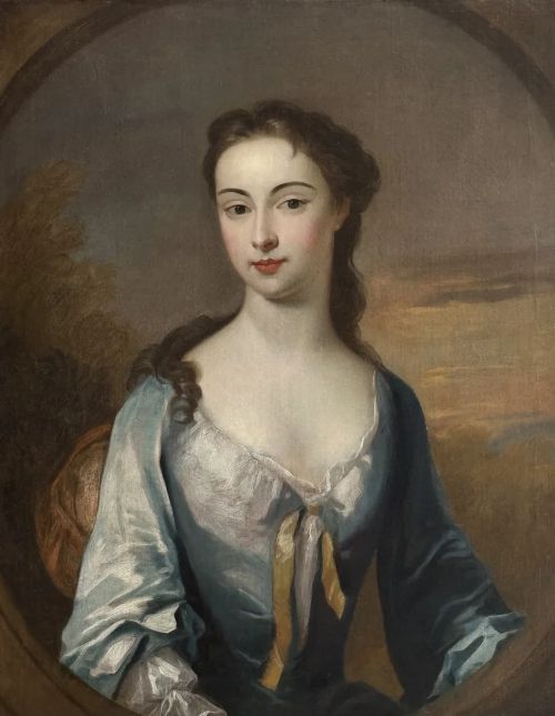fig 4. An early eighteenth-century oil portrait painting depicting a woman in a blue dress set within an oval feigned surround and a carved giltwood frame.
