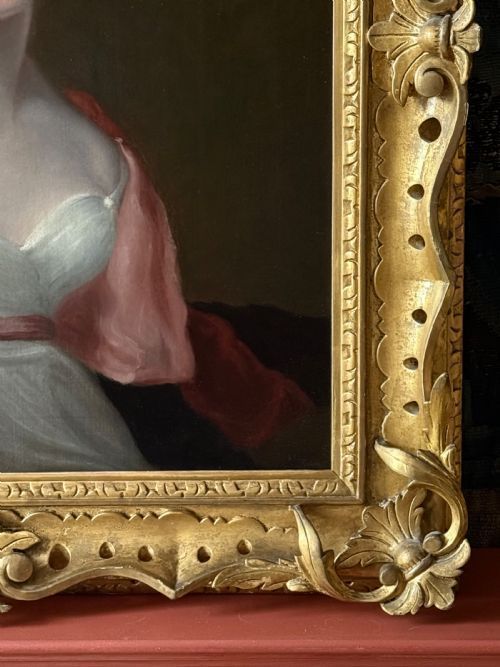 fig 3. An antique oil painting depicting a young woman in Regency dress, presented within an ornate gold giltwood frame.