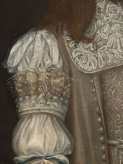 fig 3. A seventeenth-century oil portrait depicting a young gentleman wearing an intricate lace collar and embroidered clothing in a carved silvered frame.