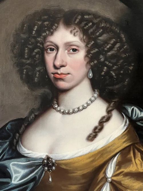 fig 2. A 17th-century oil portrait of a woman wearing a gold and blue gown with pearl jewellery, painted within a feigned oval canvas frame.
