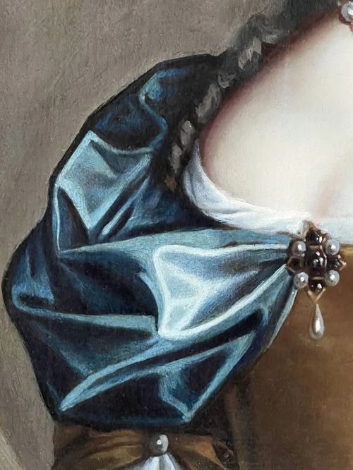 fig 5. A 17th-century oil portrait of a woman wearing a gold and blue gown with pearl jewellery, painted within a feigned oval canvas frame.