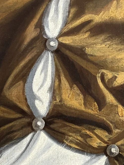 fig 8. A 17th-century oil portrait of a woman wearing a gold and blue gown with pearl jewellery, painted within a feigned oval canvas frame.