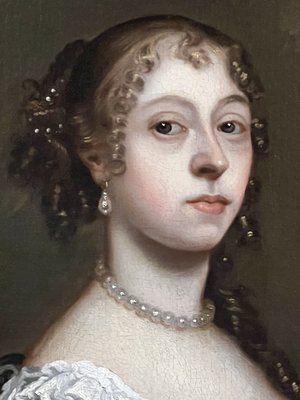 fig 1. A seventeenth-century portrait painting of a lady in a blue silk dress picking oranges, set within an ornate gilded frame.