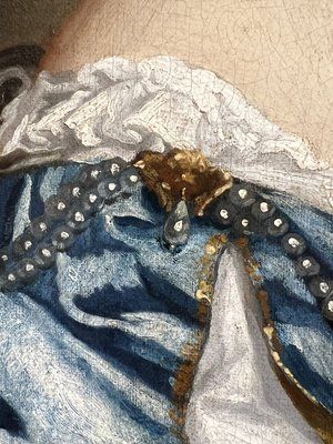 fig 2. A seventeenth-century portrait painting of a lady in a blue silk dress picking oranges, set within an ornate gilded frame.