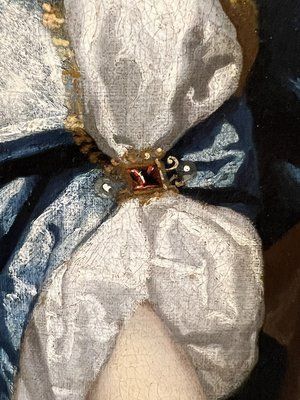 fig 8. A seventeenth-century portrait painting of a lady in a blue silk dress picking oranges, set within an ornate gilded frame.
