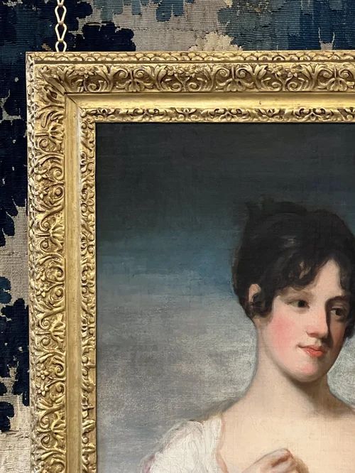 fig 4. An oil painting on canvas in an ornate gilt frame depicting a young lady in a white dress having her palm read by a fortune teller in a red hood.