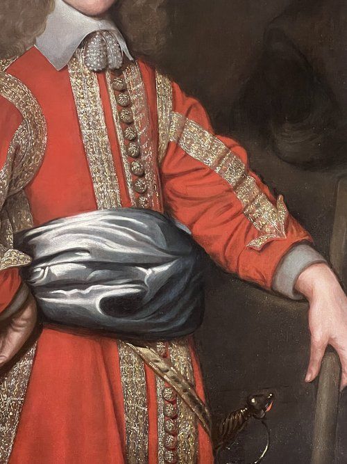 fig 2. A 17th-century oil portrait depicting a male military officer in an embellished red tunic with a wide collar and silver waist sash.