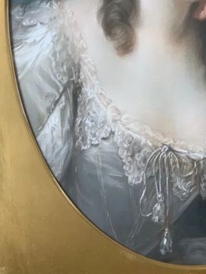fig 2. An 18th-century oval pastel portrait of a woman with curly hair wearing a white lace dress in a gold gilt frame.