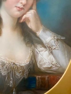 fig 3. An 18th-century oval pastel portrait of a woman with curly hair wearing a white lace dress in a gold gilt frame.